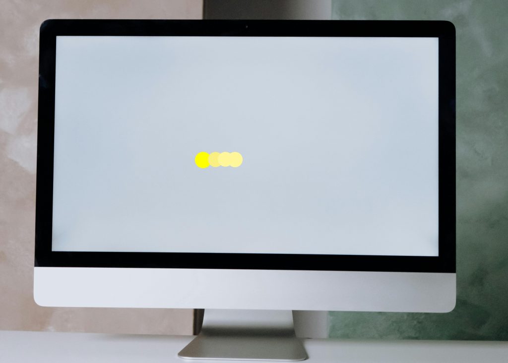 Picture of computer screen with yellow ball in center of screen made to look like it is moving from right to left